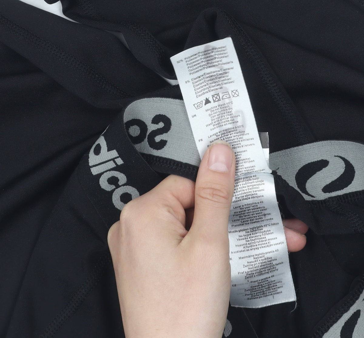 Brand and care label for Sondico boys’ black compression leggings 13 years