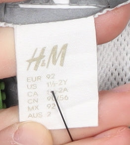 Brand and care label for H&M boys’ grey star patterned raincoat, hooded, size 2, years