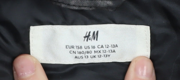 Brand and care label for H&M boys’' black puffer jacket 12-13 years winter
