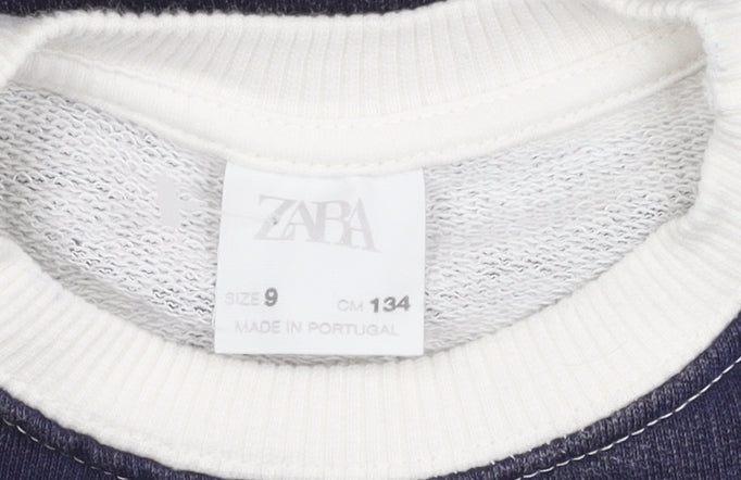 Brand and care label for Zara girls’ white striped sweatshirt, 9 years, pullover style