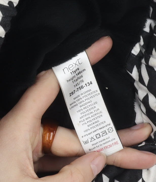Brand and care label for Next girls’' black white houndstooth puffer jacket 11y