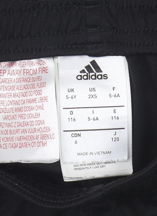 Brand and care label for Adidas boys’ black athletic shorts 5-6 years football sports wear