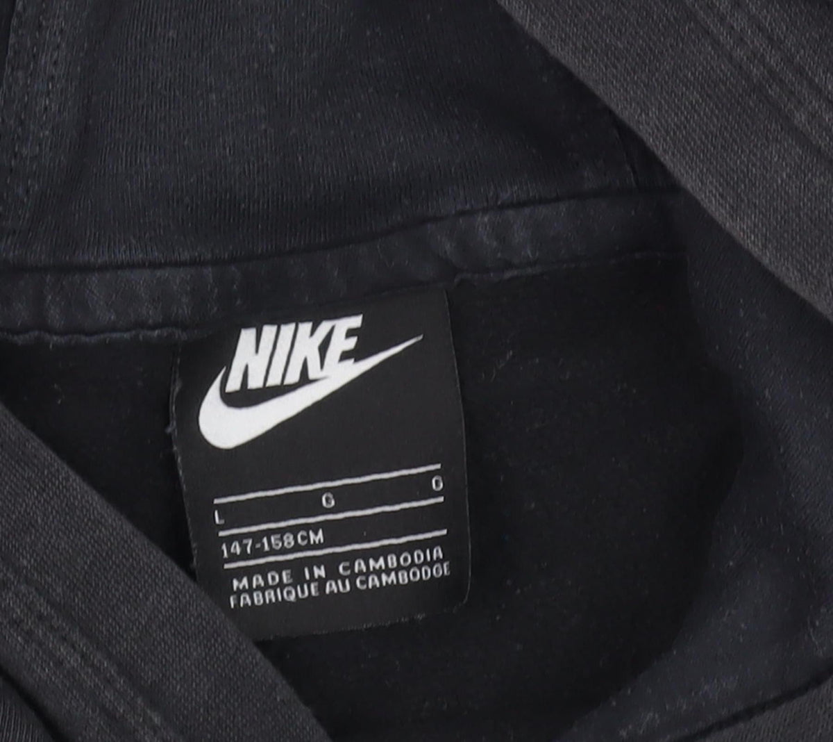 Close-up detail of Nike boys’ black hoodie large pullover fleece casual