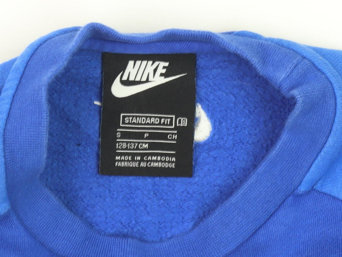 Close-up detail of Nike boys’ blue pullover sweatshirt s with logo