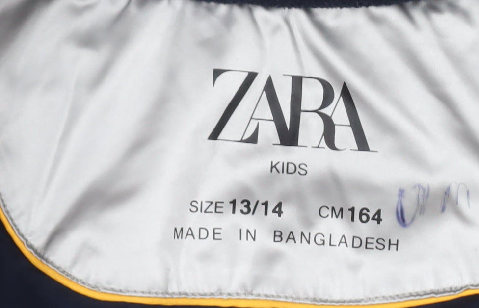 Close-up detail of Zara girls’ silver puffer jacket 13-14 years hooded quilted