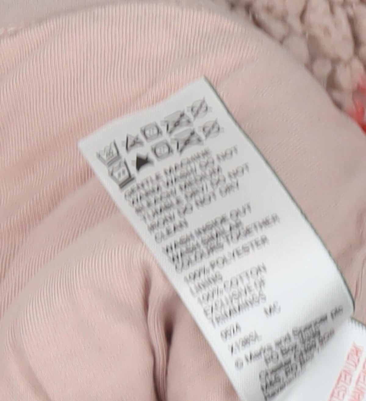 Brand and care label for Marks & Spencer girls’ pink heart jacket, 12 months