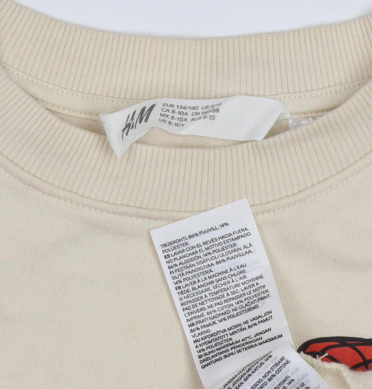 Close-up detail of H&M boys’ beige spiderman sweatshirt 8-10 years