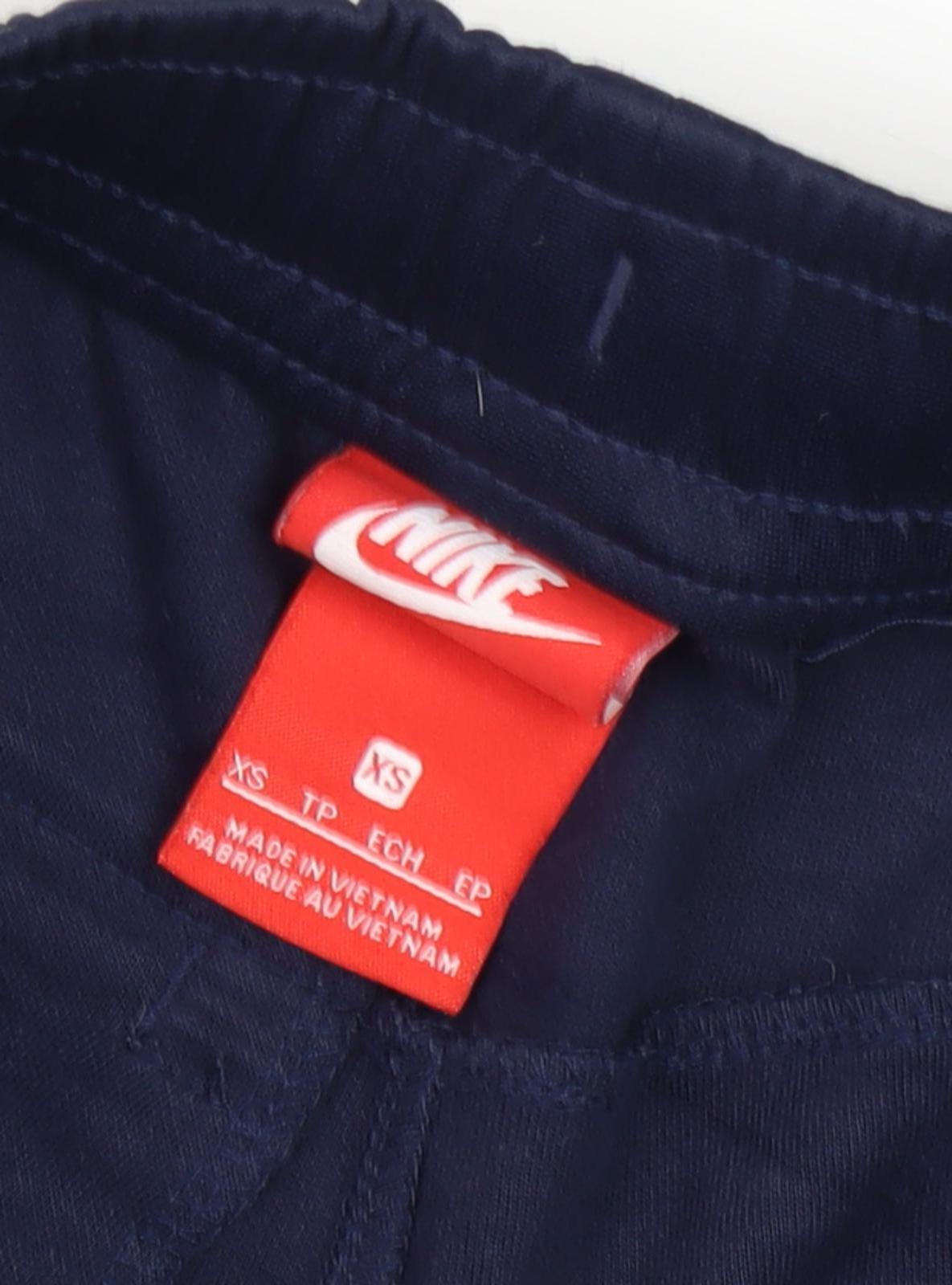 Close-up detail of Nike boys’ blue jogger trousers xs with quick dry feature