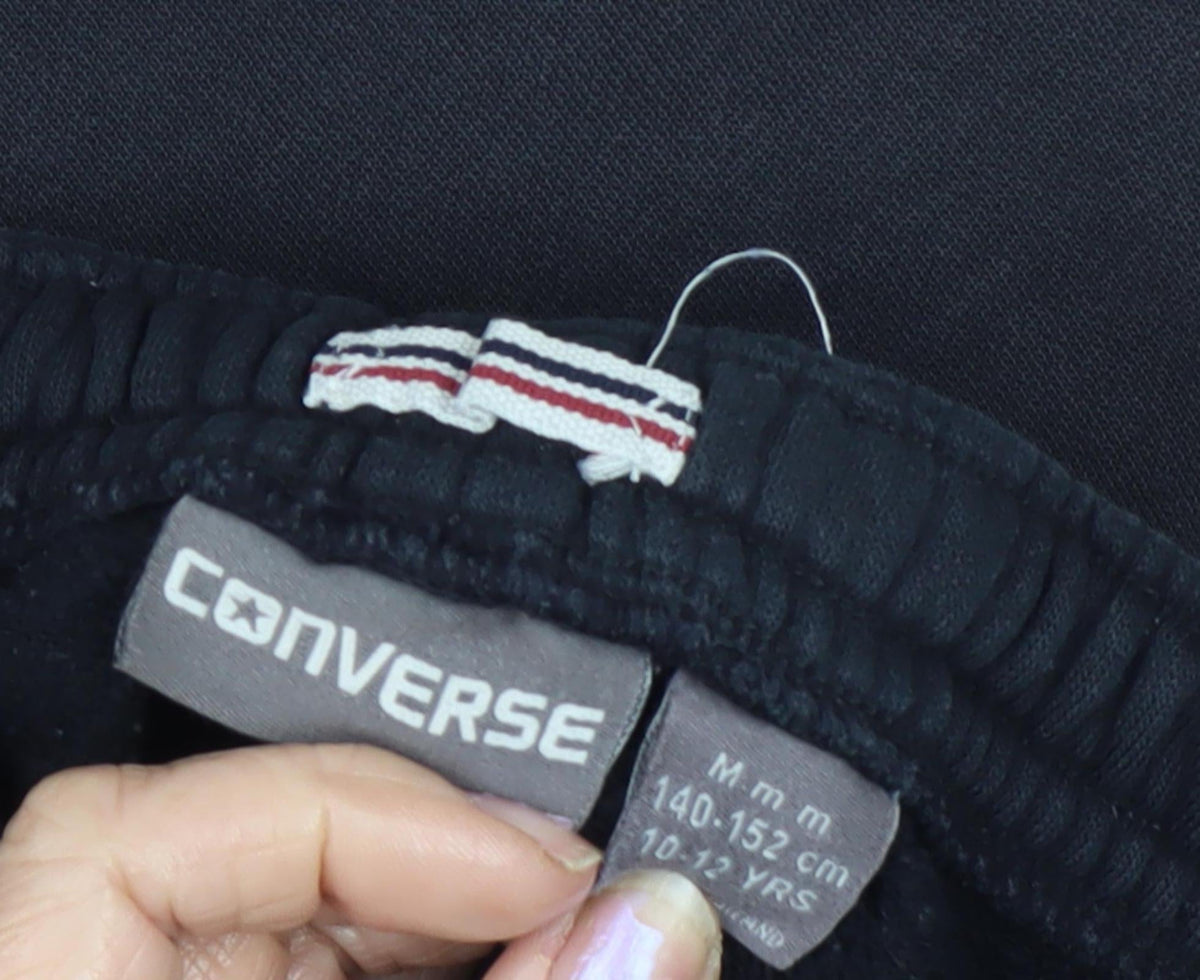 Close-up detail of Converse boys’ black jogger trousers 10-12 years