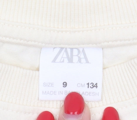 Brand and care label for Zara girls’ ivory long sleeve t-shirt 9 years graphic print