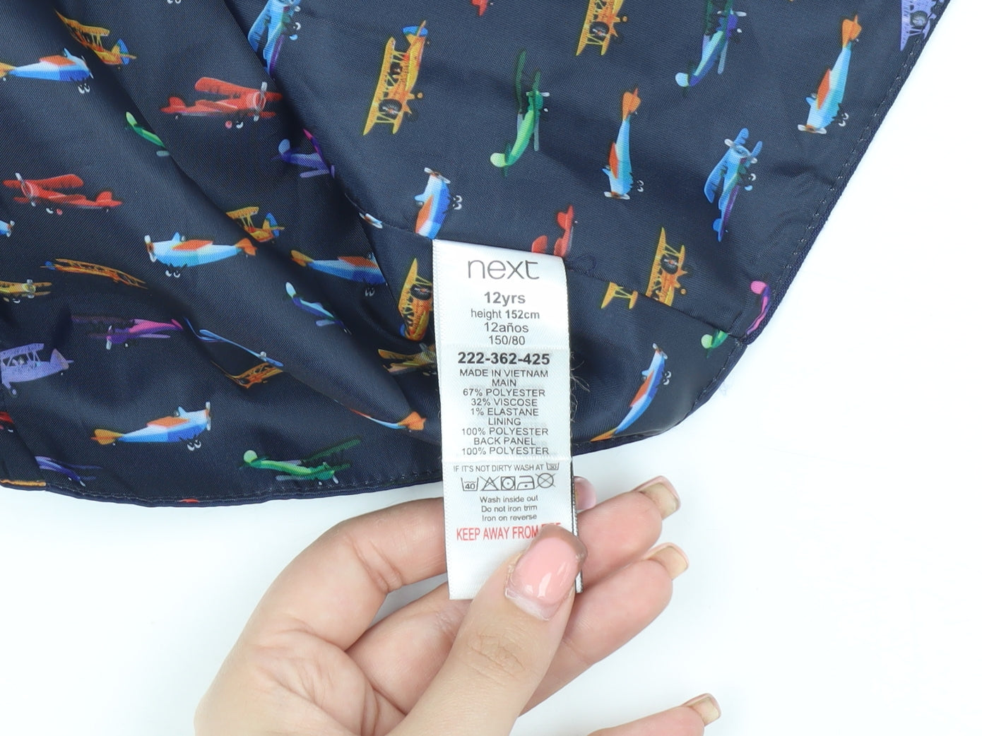 Close-up detail of Next boys’ blue suit waistcoat, 12 years, planes theme