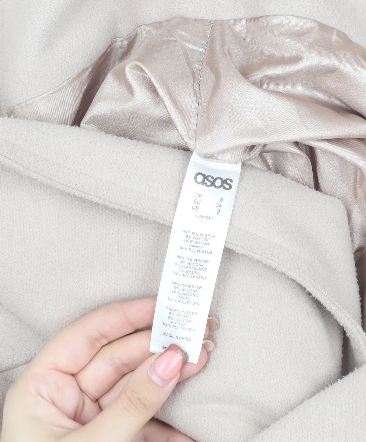 Brand and care label for ASOS Women's Beige Long Coat, size 6, with Button Accent