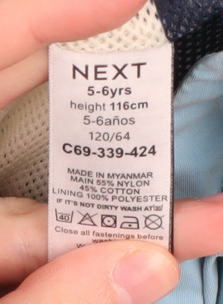 Brand and care label for Next boys’ blue hooded jacket 5-6 years with zip pockets