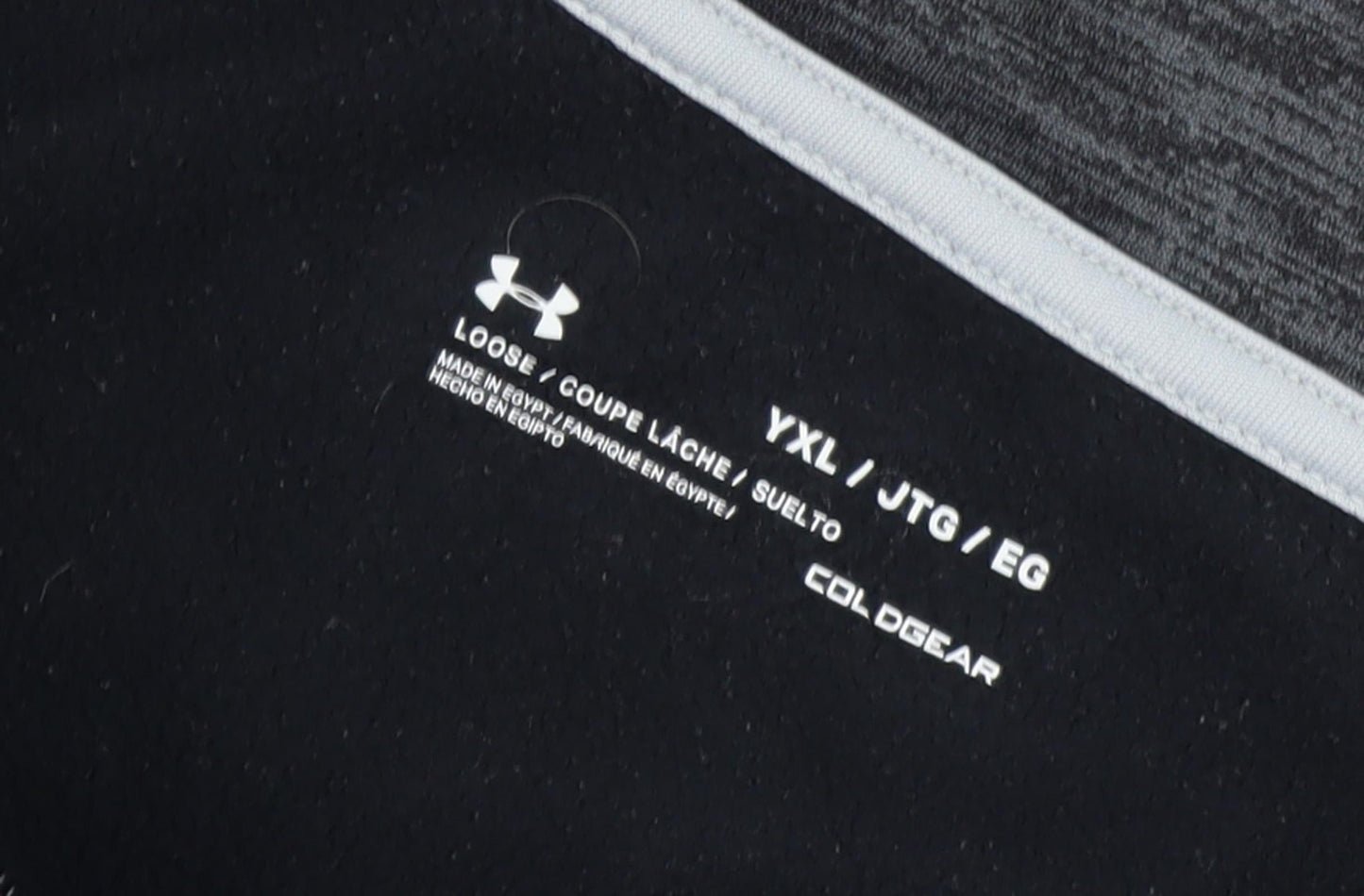 Close-up detail of Under Armour boys’ black 2xl pullover with 1/4 zip