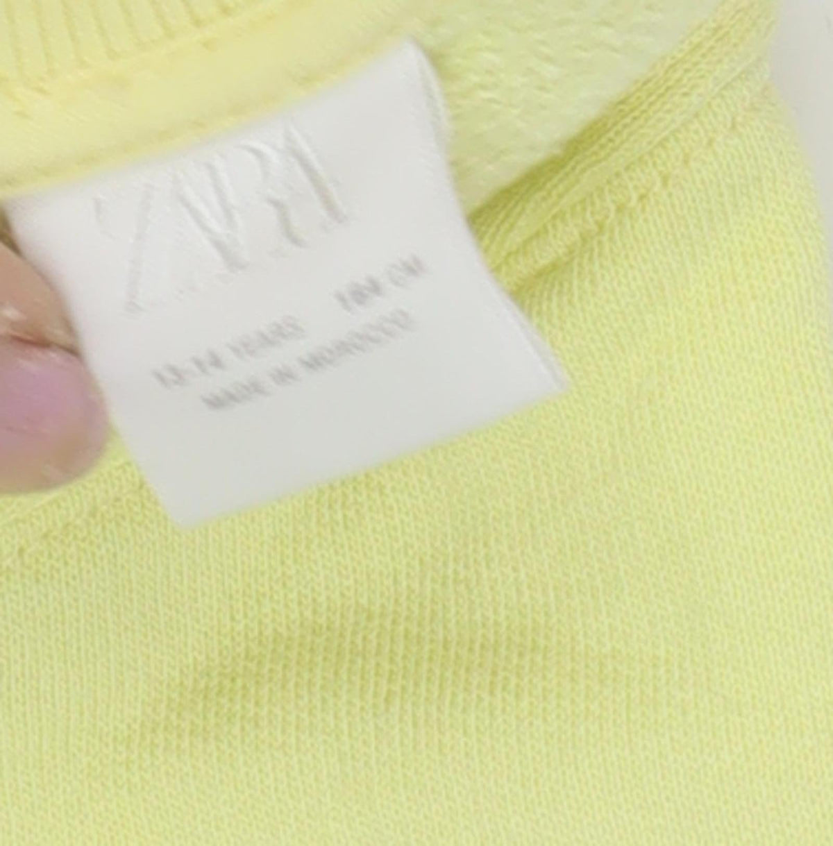 Close-up detail of Zara girls’ yellow pullover sweatshirt 13-14 years
