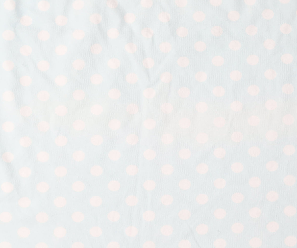 Brand and care label for Uniqlo girls’ blue polka dot t-shirt, size 9-10, years