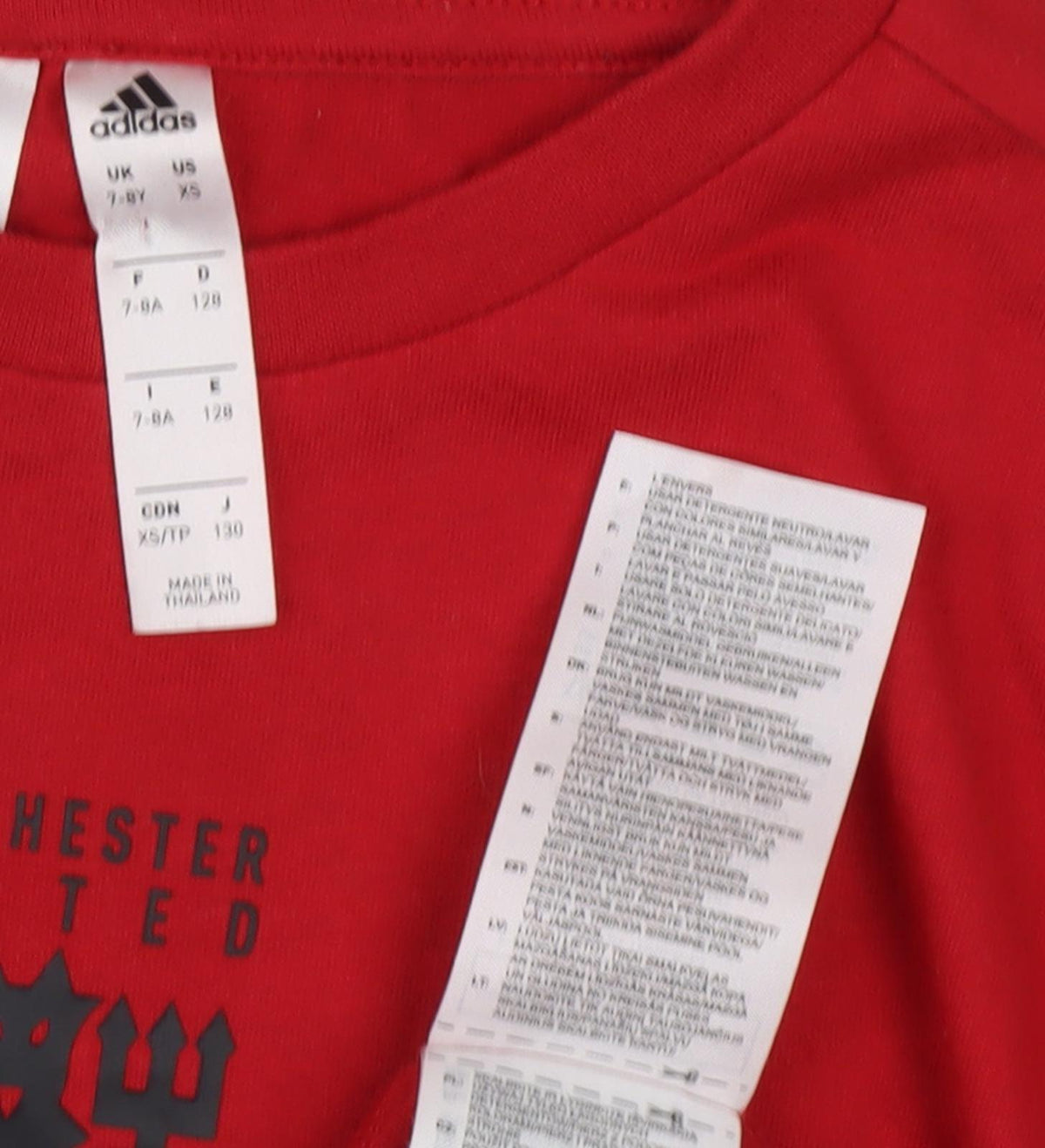 Close-up detail of Adidas boys’ red football t-shirt 7-8 years
