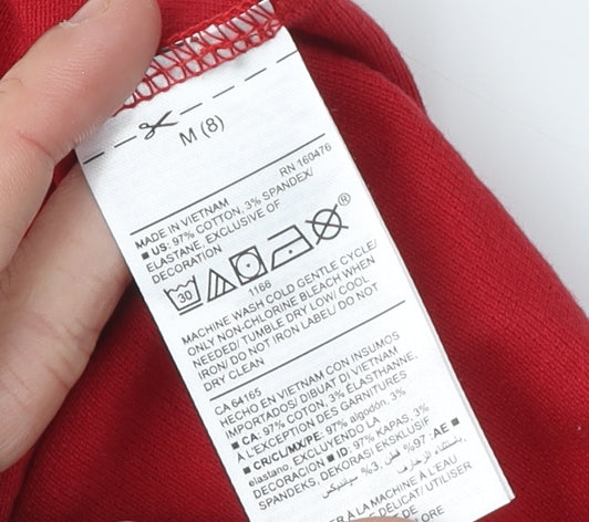 Brand and care label for Old Navy girls’ red polo shirt m short sleeve cotton