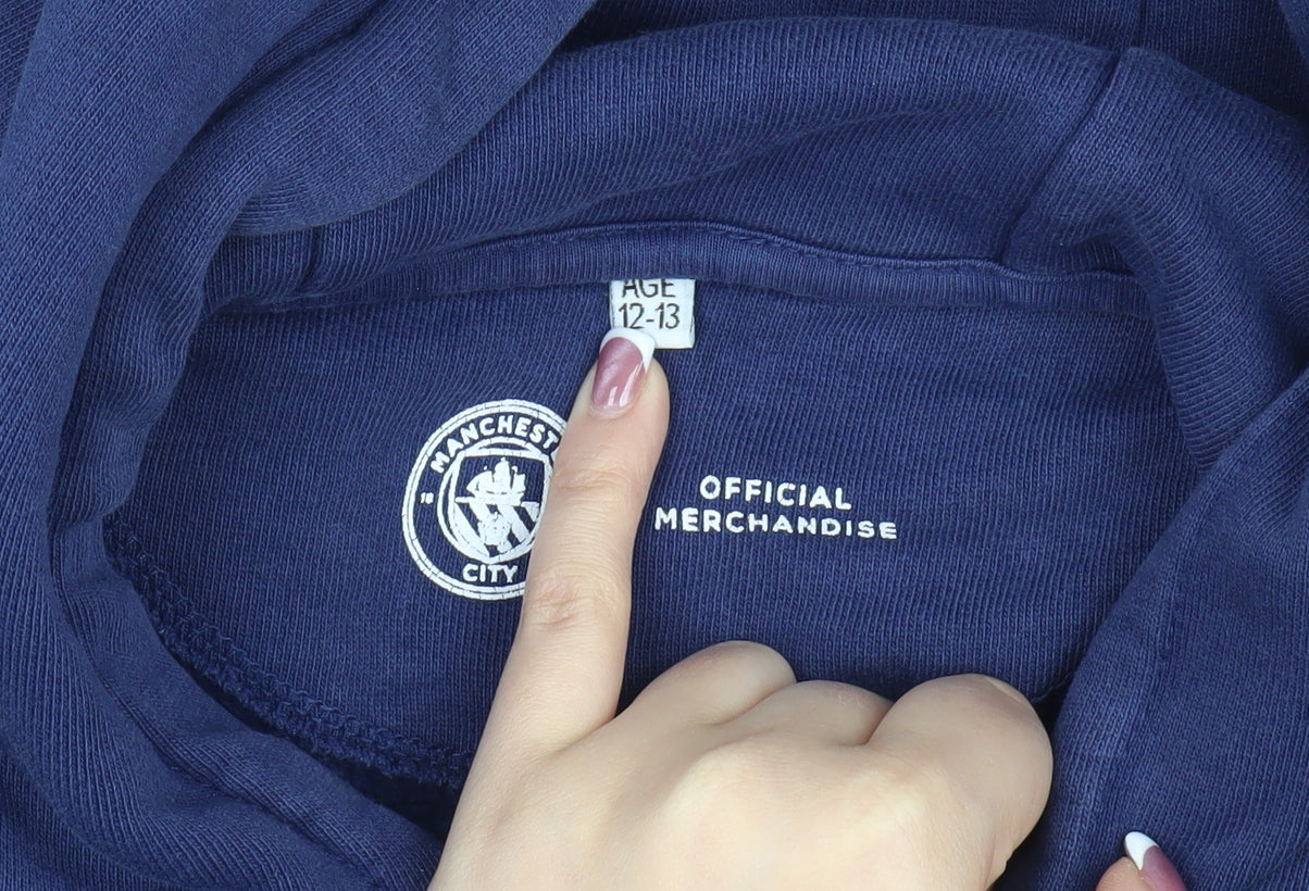 Close-up detail of Manchester City boys’ blue pullover hoodie (12-13 years)