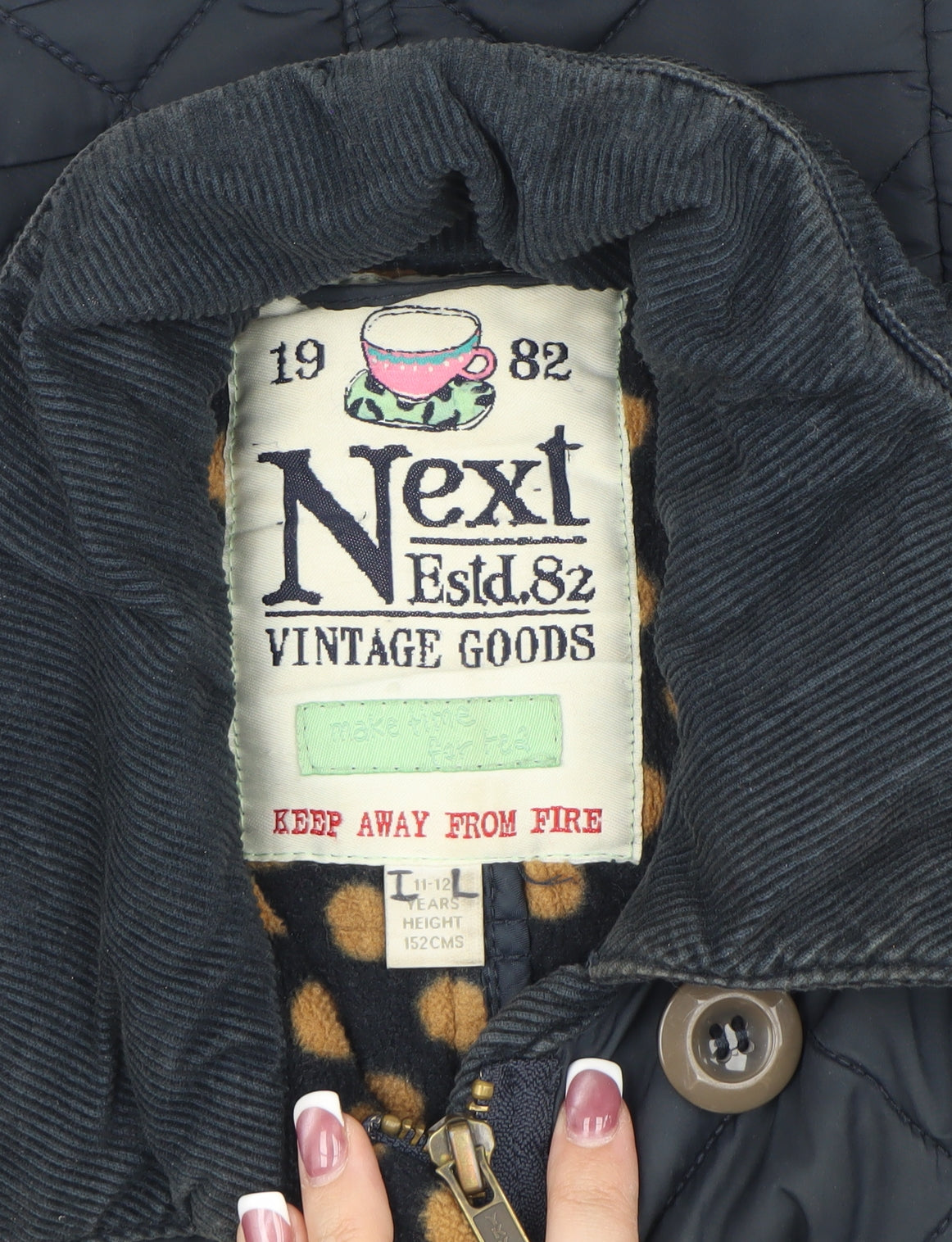 Close-up detail of Next girls’ blue quilted jacket, 11 years - stylish autumn wear