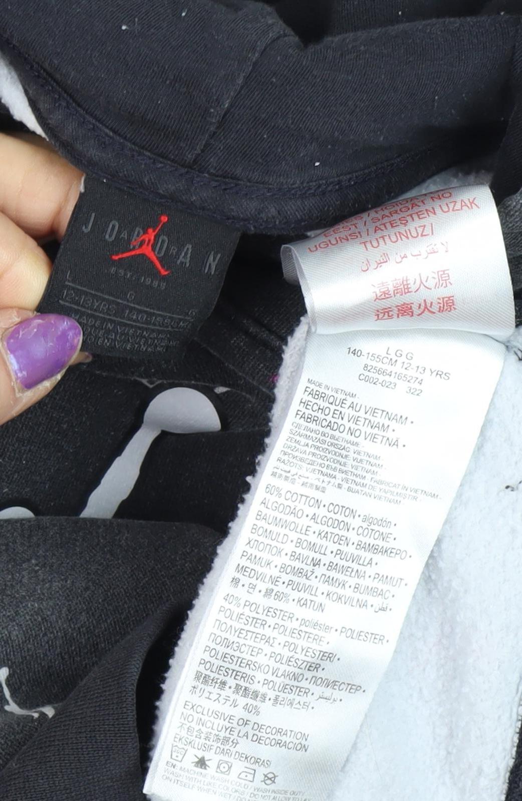 Close-up detail of Jordan girls’' black graphic hoodie 12-13 years