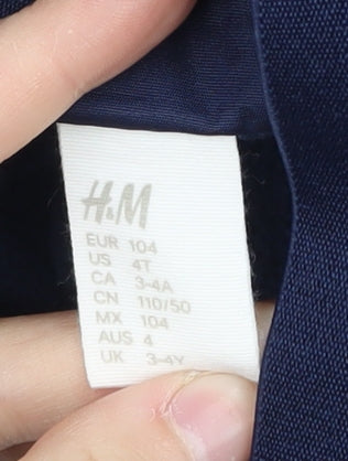 Close-up detail of H&M boys’ blue snow pants - 4 years, waterproof, winter