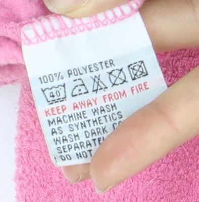 Brand and care label for Weird Fish girls’ pink fleece jacket, size 7, casual