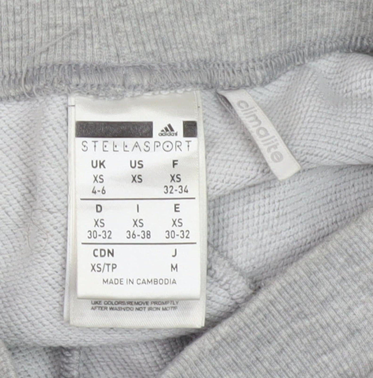 Brand and care label for Adidas girls’ grey jogger trousers xs
