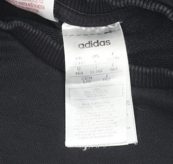 Close-up detail of adidas boys’ black sweatshirt, logo, 13-14 years, graphic print