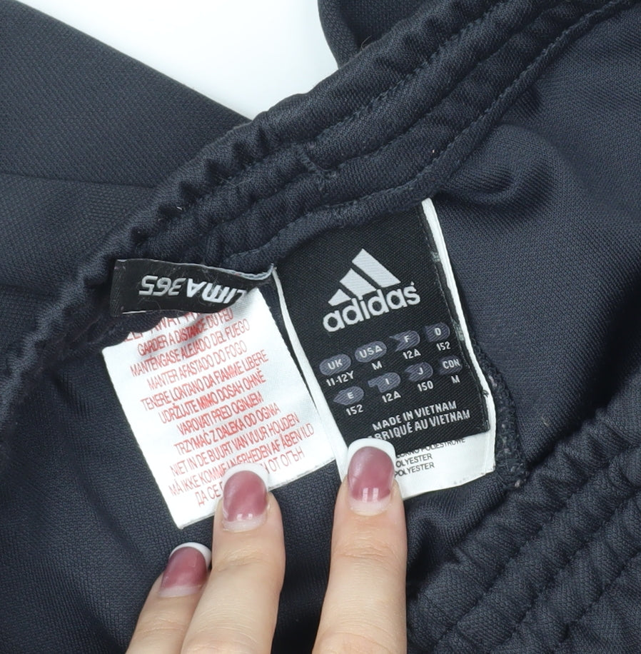 Close-up detail of Adidas boys’ black athletic shorts, size 11-12, years