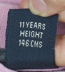 Brand and care label for Next girls’ pink graphic print long sleeve t-shirt 11-12 years