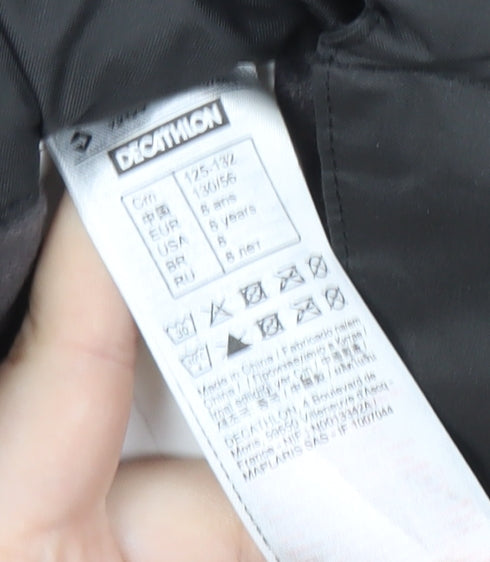 Brand and care label for Decathlon boys’' black snow pants 8 years