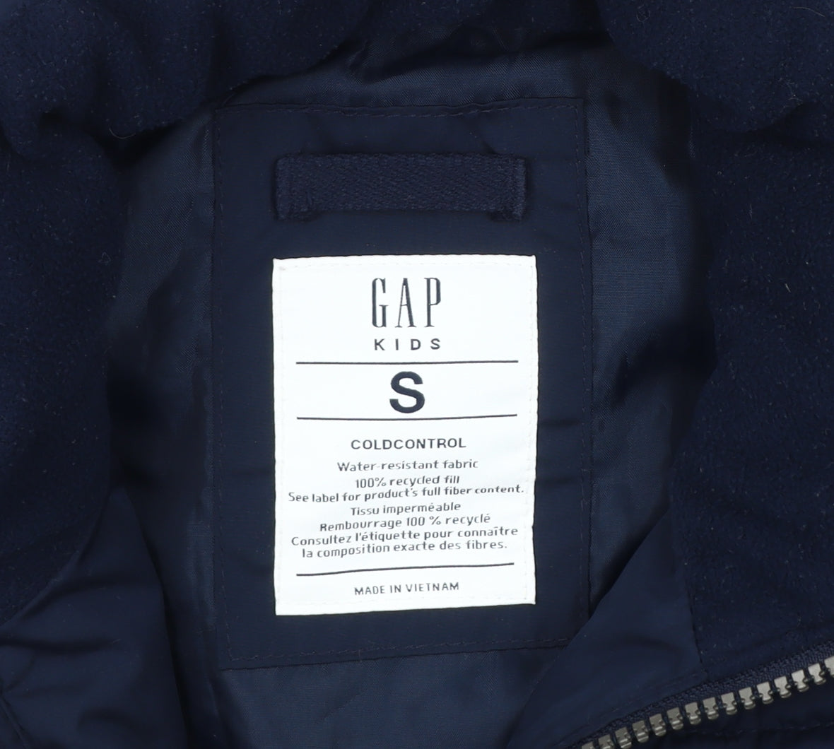 Close-up detail of Gap boys’ blue puffer jacket s winter water resistant