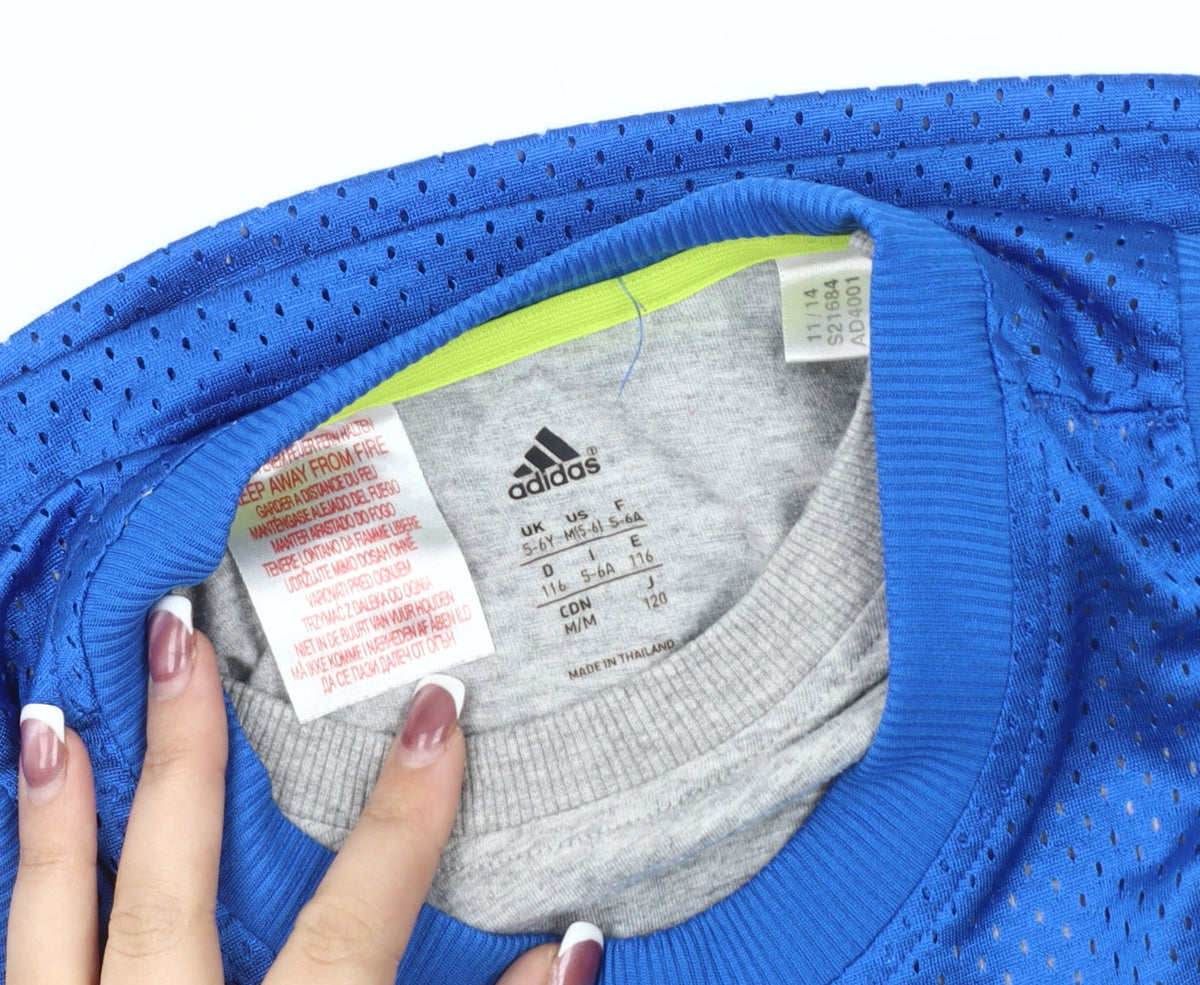 Close-up detail of Adidas boys’ blue tank top jersey 5-6 years