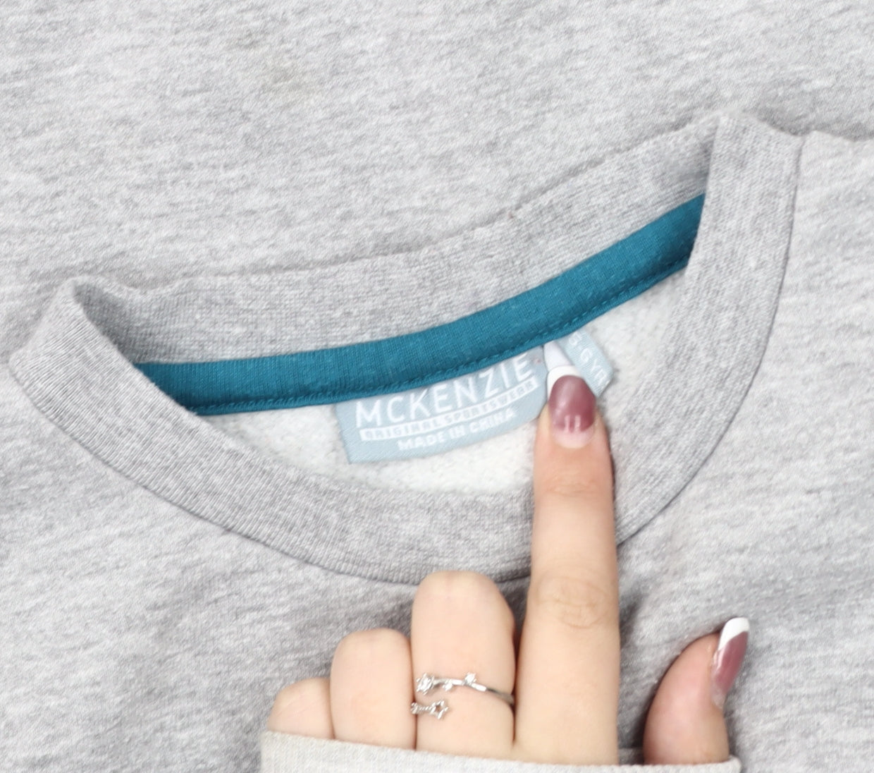 Close-up detail of McKenzie boys’ grey sweatshirt 6 years pullover logo jersey