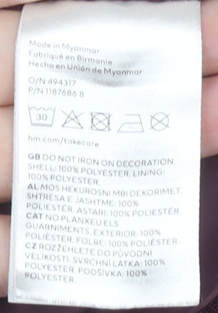 Brand and care label for H&M girls’ burgundy varsity jacket, age 9-10
