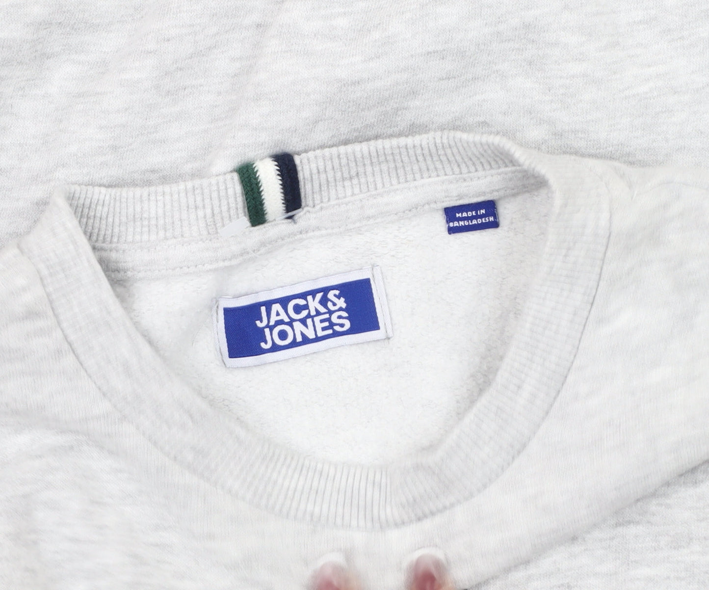 Brand and care label for Jack & Jones boys’ grey pullover sweatshirt, size 12, years