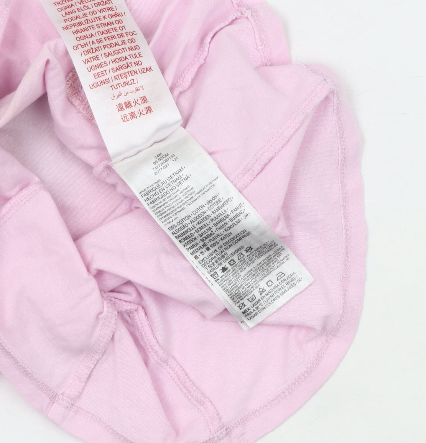 Brand and care label for Converse girls’ pink graphic t-shirt, 24 months