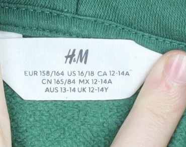 Brand and care label for H&M boys’ green colourblock pullover hoodie 12-13 years