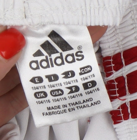 Close-up detail of Adidas boys’ white football athletic shorts, size 6, years