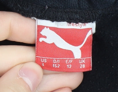 Brand and care label for Puma boys’ black jogger trousers, regular fit, size 12