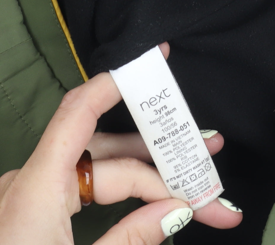 Brand and care label for Next boys’ green hooded jacket, 3 years, zip closure