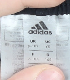 Brand and care label for Adidas boys’ black athletic shorts, size 9-10, years