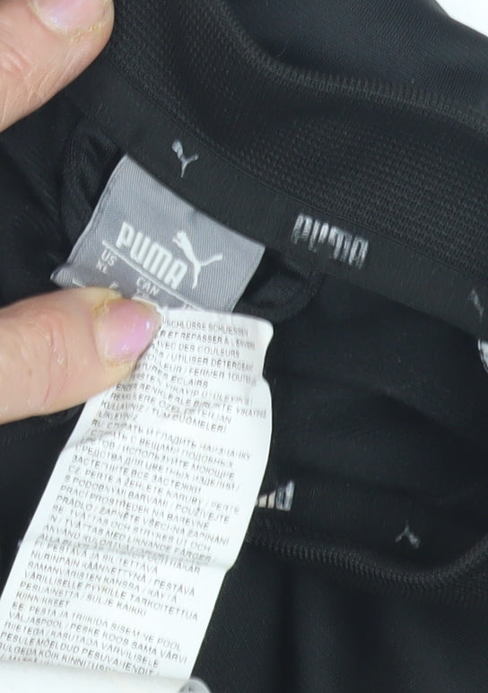 Close-up detail of Puma boys’ black track jacket - large, hooded, polyester