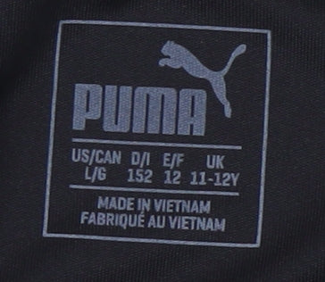 Brand and care label for Puma boys’ black athletic football shorts 11-12 years