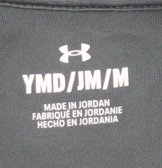 Brand and care label for Under Armour girls’' black athletic pullover, m with 1/4 zip