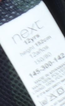 Close-up detail of Next boys’ blue puffer jacket 12 years with hood
