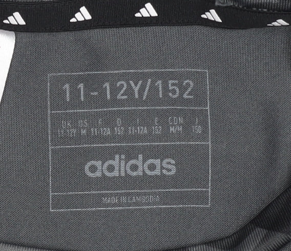 Brand and care label for Adidas girls’' black camouflage cropped t-shirt 11-12