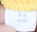 Brand and care label for Mountain Warehouse boys’ yellow fleece hoodie 3-4 years
