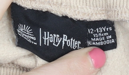 Brand and care label for Harry Potter boys’ beige jogger trousers 12-13 years